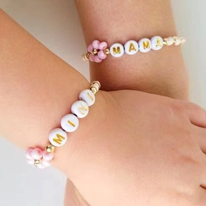 Handmade beaded bracelet set for mother and child with MAMA and MINI gold letter beads