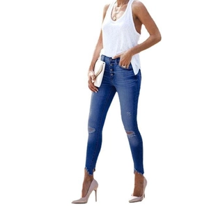 Blue high-waisted distressed skinny jeans with button fly and knee holes on white background