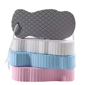 Stack of 3D high-density exfoliating bath sponges in four colors with scale texture