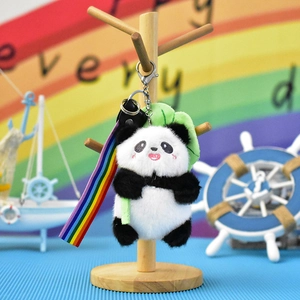 Close-up view of a cute plush panda keychain featuring a colorful rainbow lanyard strap