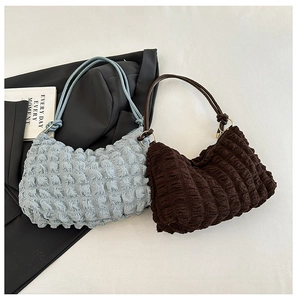 Detail of blue and brown ruched bubble cloud bags showing texture and elastic fabric