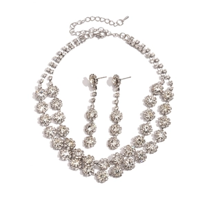 Luxurious silver flower necklace and fringe earring set with sparkling rhinestones