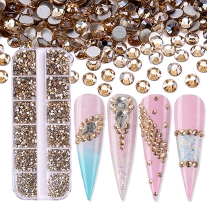 Macro detail of champagne gold flatback rhinestones for nail art in a 12-grid storage box