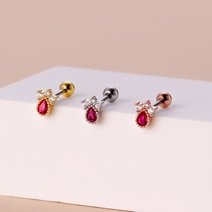 Three crown earrings in gold, silver, and rose gold with red teardrop zircon stones