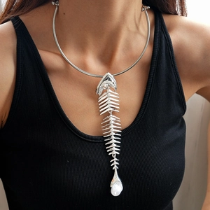 Detail shot of a silver fishbone pendant choker with a pearl accent on a female model