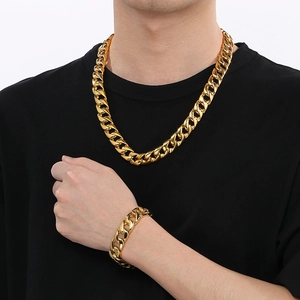 Men's 15mm gold-toned stainless steel Cuban link necklace and bracelet set on model
