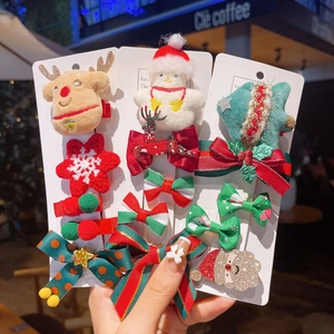 Plush Christmas hair clip set with reindeer snowman and tree designs on card