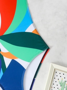 Detailed macro shot of abstract tropical print swimwear with reinforced double stitching