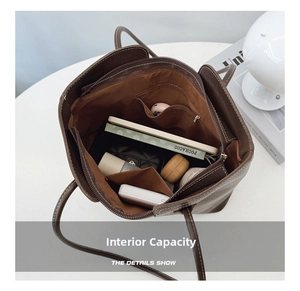 Interior view of brown tote bag showing large capacity with pockets and daily essentials