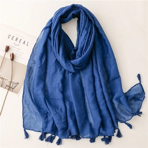 Detail of dark blue linen scarf with subtle gold sparkles and fringe edges