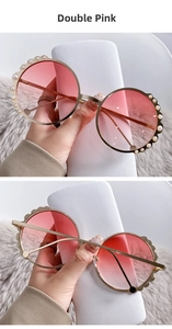 Detail of round sunglasses with decorative pearls on top edge and double pink gradient lenses