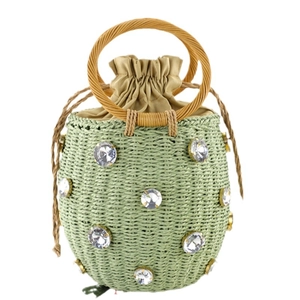 Pale green woven straw bucket bag with wood handles and rhinestone accents for summer