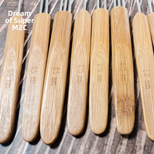 Detail of bamboo handles on dreadlock crochet hooks showing 0.5mm to 1.0mm size engravings