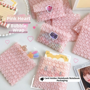 Close-up of pink heart-shaped bubble mailers with protective shockproof texture for small cards