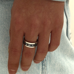 316L stainless steel ring for men with black dragon flame pattern on blue denim backdrop