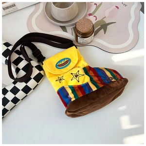 Detail view of yellow plush cowboy boot bag with rainbow stripes and star embroidery