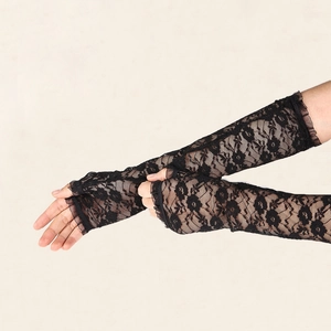 Close-up of elegant black lace fingerless gloves with floral patterns and ruffled edges