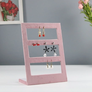 Pink velvet jewelry display stand featuring three tiers for earrings and accessories