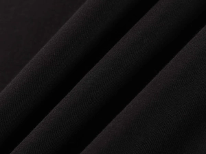 Gros plan macro du tissu thermique noir montrant la texture côtelée fine et la douceur