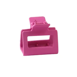 Detail of matte rose pink square hair claw clip with hollow design and metal spring