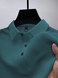 Detailed close-up of breathable ice silk polo shirt showing blue-green jacquard texture