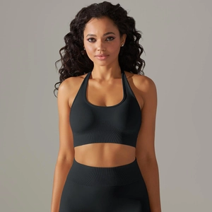 Detail of black seamless ribbed knit texture on high-impact halter neck sports bra