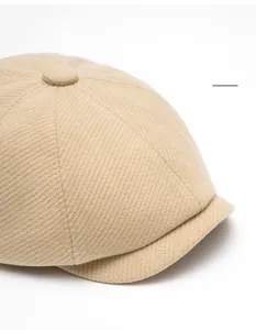 Detailed view of the beige wool blend newsboy cap showing twill texture and curved brim