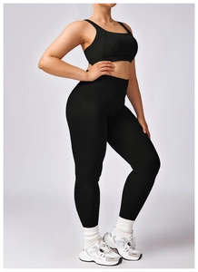 Detail of high-waist black yoga leggings and sports bra set for professional fitness wear