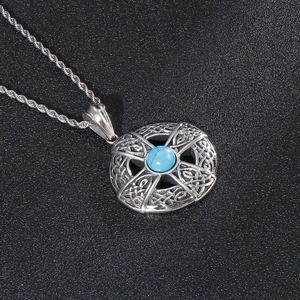 Detailed view of vintage titanium steel pendant with turquoise and Celtic knots