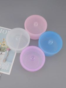 Macro view of nail tool sterilizer boxes in pink white blue and purple with filter mesh