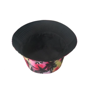Pink and yellow gradient bucket hat with black coconut tree prints for sun protection
