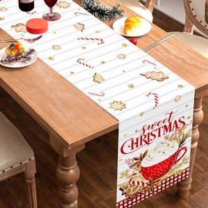 Christmas table runner with gingerbread and candy canes on a dark wooden dining table