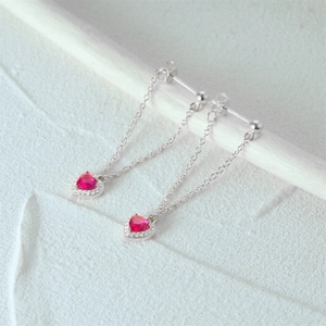 Detailed macro view of S925 silver heart tassel earrings with red crystal and diamonds