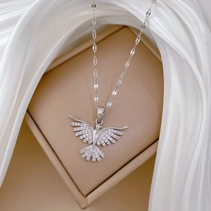 Close-up of sparkling phoenix wing pendant with cubic zirconia on fine silver chain