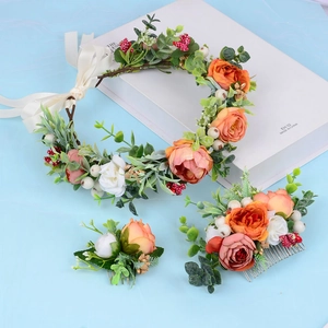 Detail of floral hair accessory set with orange flowers, red berries and silk ribbons