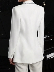 Back view of white slim fit blazer with rhinestone collar and tailored waist silhouette