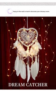 Macro detail of heart dreamcatcher with soft white feathers and warm glowing LED lights