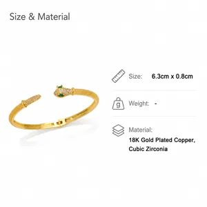Macro detail of snake-shaped open bracelet in 18K gold plating with cubic zirconia gems