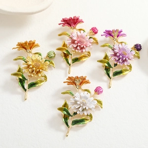 Detailed close-up of four colorful enamel daisy brooches with gold alloy bases and petals