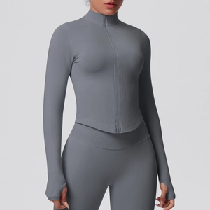 Detail of grey athletic yoga jacket with thumbholes and ribbed compression fabric texture