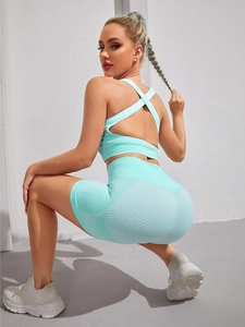 Detail of mint green seamless yoga set featuring honeycomb texture and cross-back bra