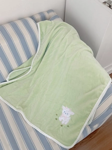 Detailed embroidery of a cute lamb with a pink bow on soft green fleece bath towel