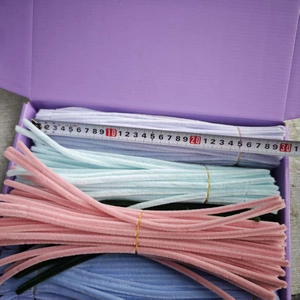 Detail showing 30cm colorful plush pipe cleaners in a box with a measuring tape