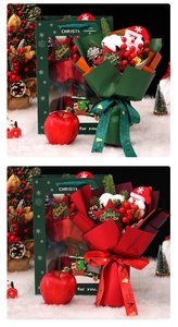 Detail of Christmas apple bouquets with Santa plush, pine cones and festive gift bags