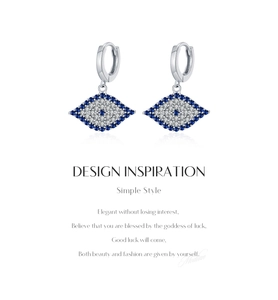 Macro view of vintage silver eye earrings with sparkling blue and clear zircon stones