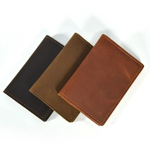 Flat lay of genuine crazy horse leather passport covers in three shades of brown