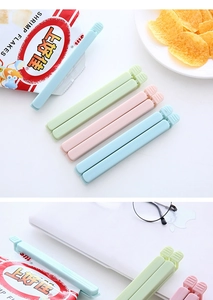 Detail view of large plastic food sealing clips in blue, green, and pink pastel colors