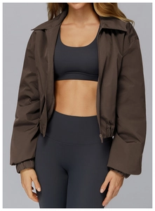 Detail of loose windproof sports jacket with elastic hem and brown zip-up design