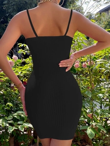 Close-up of black ribbed knit fabric and back fit of the bodycon mini dress