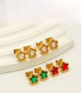 Detail of star-shaped stud earrings with zircon insets on white wavy jewelry display